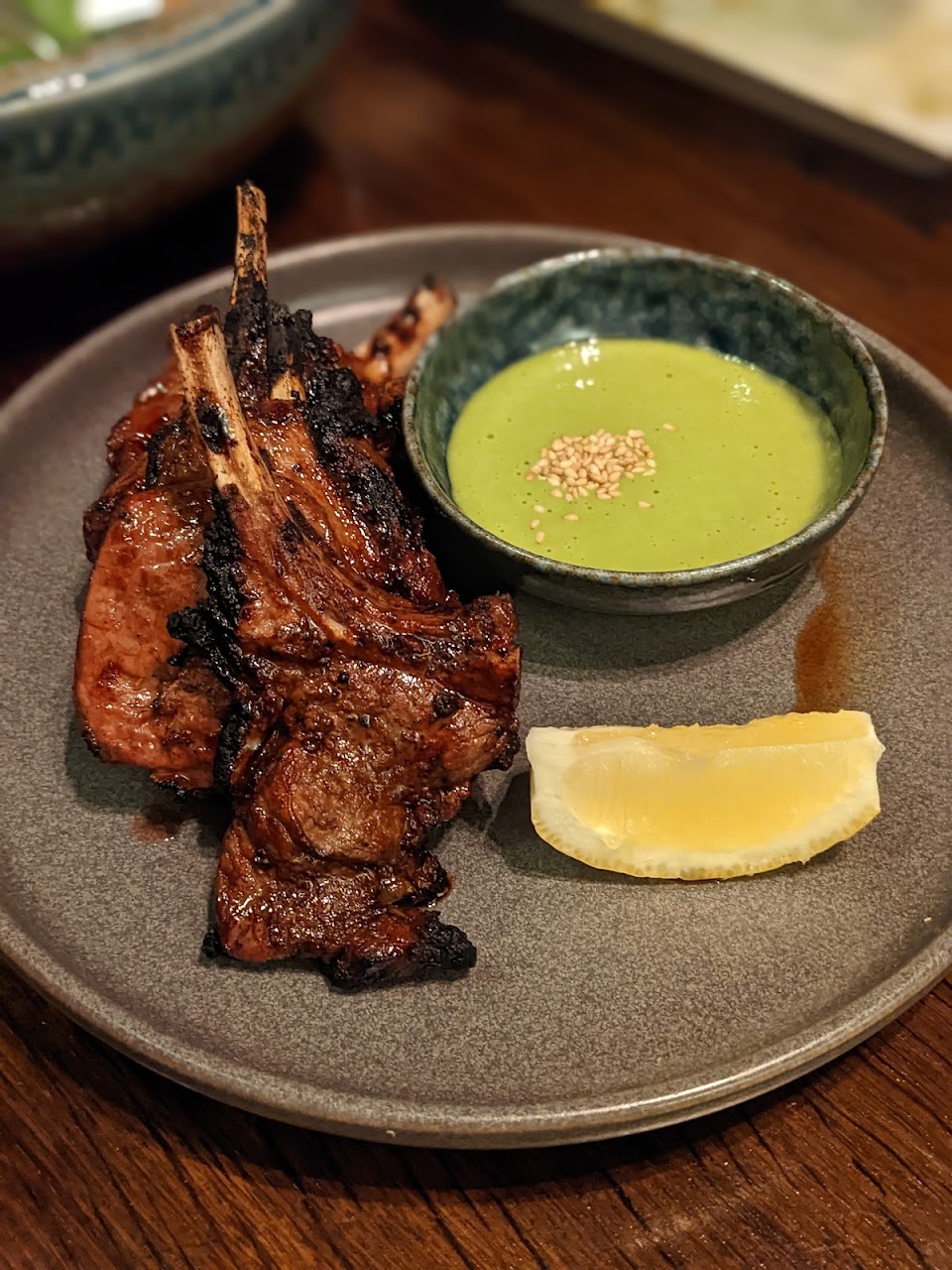 Grilled skewer-style dish with dipping sauce at Saké Restaurant & Bar